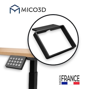 May include: A black rectangular mounting bracket for a desk controller, featuring a flat top plate with two screw holes and a hollow frame. The MICO3D logo is visible at the top, and the text MADE IN FRANCE with a flag icon is at the bottom.