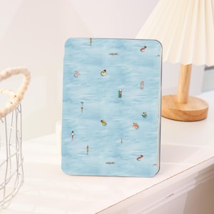 May include: A rectangular tablet case featuring a light blue water design with small figures floating on the surface. The case has a glossy finish and a rounded edge. The design includes various people and objects in the water.