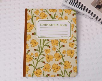 May include: A composition book with a floral pattern of yellow flowers and green stems on a cream backdrop. The cover displays "COMPOSITION BOOK" with space for a name, plus "COLLEGE" and "100 PAGES". The spine is brown.