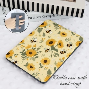 May include: A yellow Kindle case with a sunflower and bee pattern. The case has a black hand strap.
