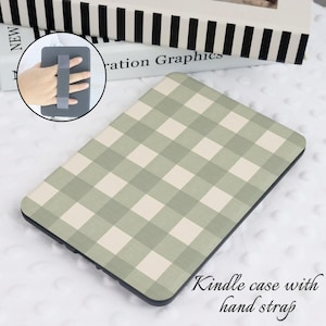 May include: A green and white gingham patterned Kindle case with a black hand strap. The case is designed to fit a Kindle e-reader.  Kindle case with hand strap.