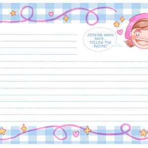 May include: A rectangular notepad with a light blue and white gingham pattern border. The center features horizontal lines for writing. A cartoon character with a pink head covering and the text COOKING MAMA SAYS... FOLLOW THE RECIPE! appears in the top right corner, surrounded by pink swirls, small yellow stars, and pink hearts.