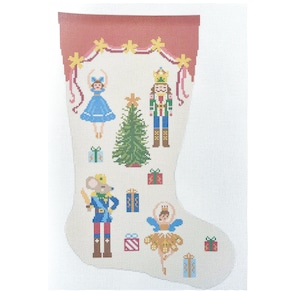 May include: A needlepoint canvas shaped like a Christmas stocking featuring a cream background with a red cuff. The design includes a nutcracker, a mouse soldier, two ballerinas, a green Christmas tree, and several colorful gift boxes.