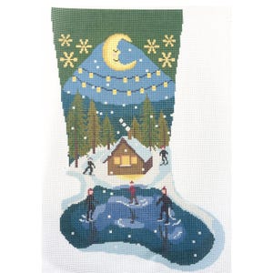 May include: A needlepoint canvas shaped like a Christmas stocking featuring a winter scene with a crescent moon, yellow string lights, pine trees, a snow-covered cabin, and figures ice skating on a dark blue pond with falling white snowflakes.