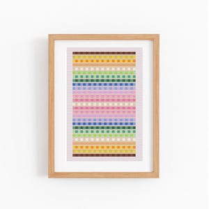 May include: A framed cross-stitch artwork with a vibrant, multi-coloured design. The pattern showcases horizontal stripes in shades of yellow, orange, green, blue, and pink. The piece is presented in a light brown wooden frame, suitable for home decor.