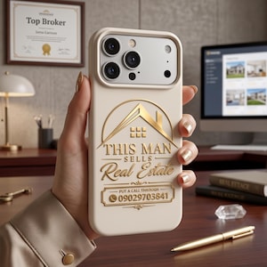 May include: A cream-coloured smartphone case featuring a gold embossed graphic of a house roofline above the text THIS MAN SELLS Real Estate and a rectangular box containing the phone number 09029703841 with a small telephone icon.