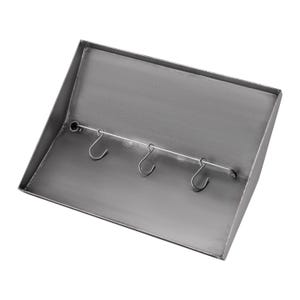 May include: A metal key holder with four hooks. The key holder is made of a silver metal and has a rectangular shape.