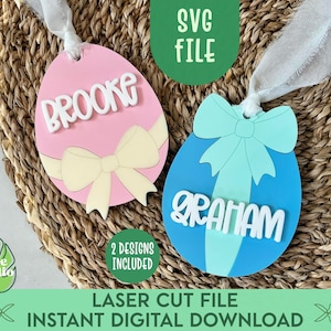 May include: Two laser cut Easter egg ornaments with bows. The pink egg has the name "Brooke" and the blue egg has the name "Graham".