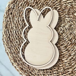 May include: A wooden cutout of a bunny rabbit, perfect for crafting and decorating. The cutout is unfinished and ready to be painted or stained.