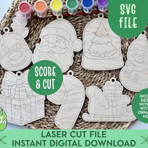 May include: Laser-cut wooden Christmas ornaments in various shapes, including a reindeer, Santa Claus, a snowman, and a gift box. The ornaments are designed for DIY painting. The image includes the text "SVG FILE", "SCORE & CUT", and "LASER CUT FILE INSTANT DIGITAL DOWNLOAD".