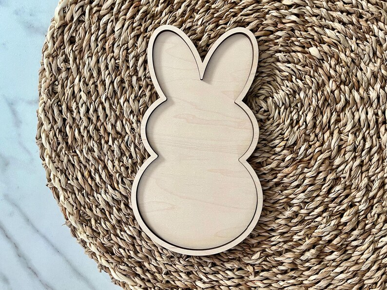 May include: A wooden bunny-shaped cutout, perfect for crafting and decorating. The cutout is unfinished and ready to be painted or stained.