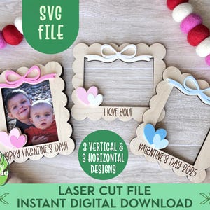 May include: Three laser cut Valentine's Day picture frames with scalloped edges. The frames are made of wood and have a white background. The top frame has a pink bow and the text "I Love You!" The middle frame has a pink bow and the text "Happy Valentine's Day!" The bottom frame has a blue bow and the text "Valentine's Day 2025".