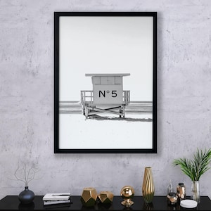 May include: Black and white photograph of a lifeguard stand on a beach. The stand is labeled "N&deg; 5".