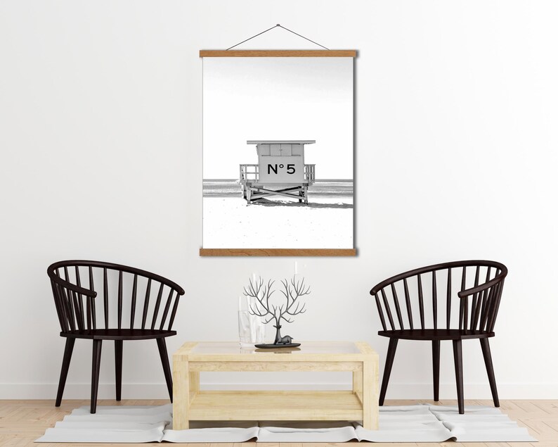 May include: Black and white photograph of a lifeguard stand on a beach. The stand has the number "N&deg; 5" on the front.