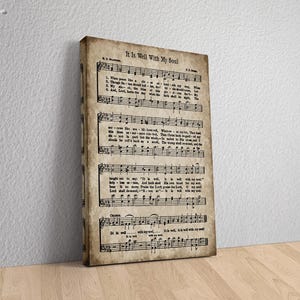 May include: Vintage sheet music print with the title "It Is Well With My Soul". The music notes and lyrics are printed in black ink on a cream-colored background.