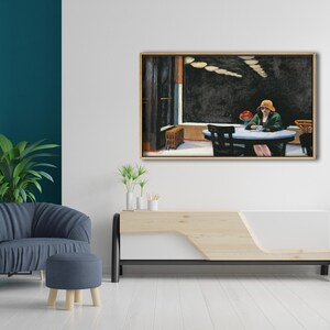 May include: A painting of a woman sitting at a table in a restaurant. The woman is wearing a green jacket and a hat. The restaurant is dimly lit and has a dark wood floor. The painting is framed in a light wood frame.