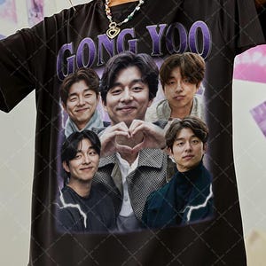 May include: Black t-shirt with a graphic print of Gong Yoo and other actors. The text "Gong Yoo" is printed in purple letters on the shirt.