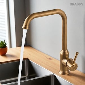 May include: A bronze-colored kitchen faucet with a gooseneck spout. Water flows from the faucet into a stainless steel sink. The faucet has a single lever handle and is mounted on a wooden countertop. The brand name "BRASIFY" is visible.