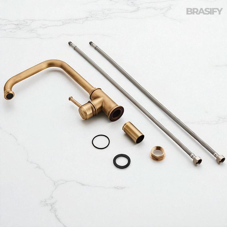 May include: An antique brass kitchen faucet with a curved spout, handle, and various installation components. The faucet is accompanied by two flexible supply lines, a cylindrical piece, and several rings and fittings. The brand name "BRASIFY" is visible in the top right corner.