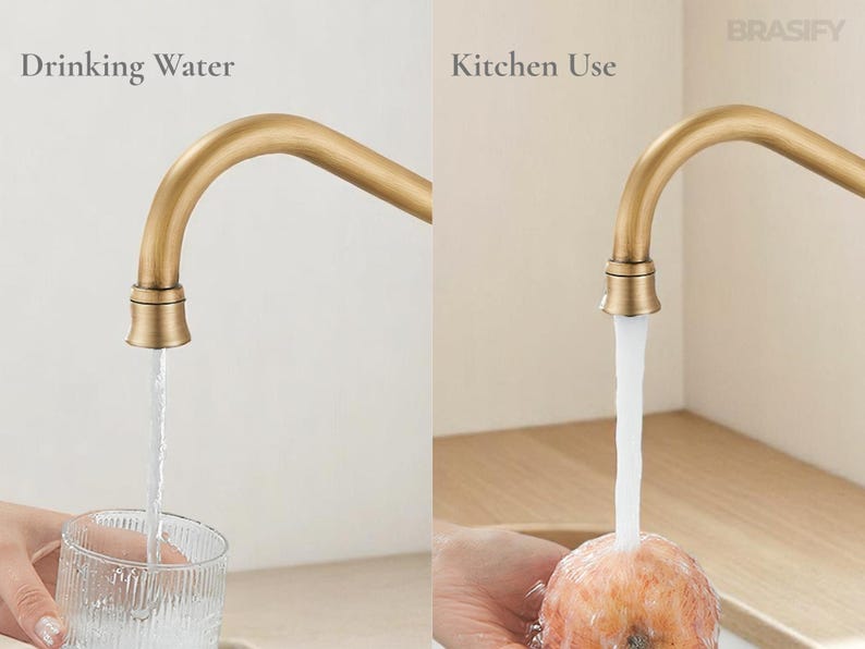 May include: A close-up of a gold-colored faucet with water flowing into a glass and onto a piece of fruit. The text "Drinking Water" and "Kitchen Use" are visible. The faucet has a curved spout and is set against a neutral background.