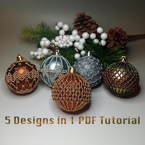 May include: An assortment of five beaded Christmas ornaments in various colors, including brown, silver, and gold. The ornaments are arranged in front of pine branches, white berries, and pine cones. Text at the bottom reads "5 Designs in 1 PDF Tutorial."