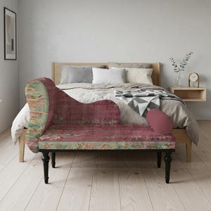 May include: A chaise lounge with a burgundy floral pattern and black legs. The chaise lounge has a curved back and armrest, and a matching bolster pillow. The design features a mix of colors, including burgundy, green, and yellow.