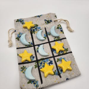 Ceramic Tic-tac-toe to-go bag. Blue Moons and Yellow Stars, ceramic pieces just under 1in. *NOT FOR KIDS under 3yrs.