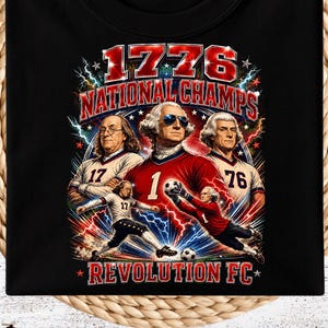 May include: A black t-shirt featuring a graphic print with the text 1776 NATIONAL CHAMPS REVOLUTION FC. The design depicts historical figures in football uniforms, including one wearing sunglasses, alongside football players and lightning bolts.