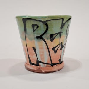 RESIST cup with colored slips and copper glaze