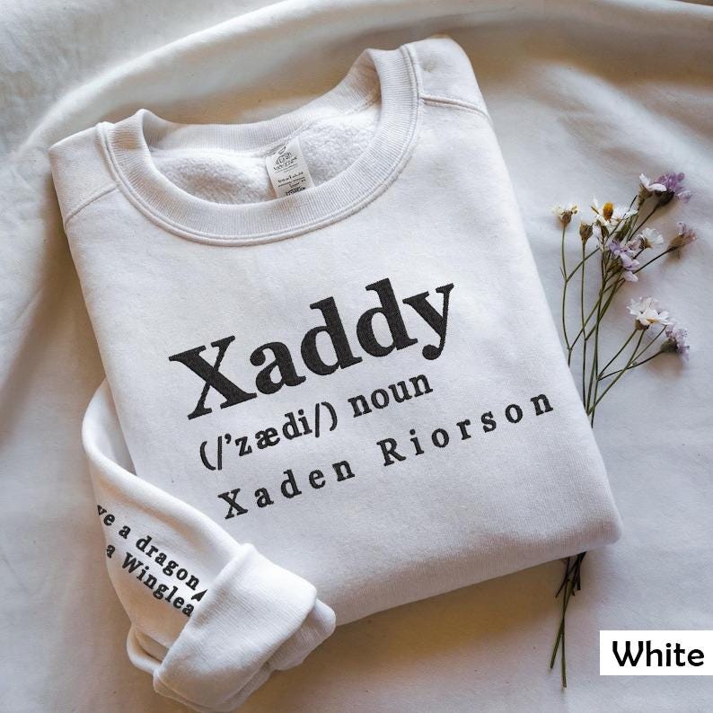 May include: White sweatshirt with the word "Xaddy" defined as a noun, with the phonetic pronunciation and the name "Xaden Riorson" printed on the front.