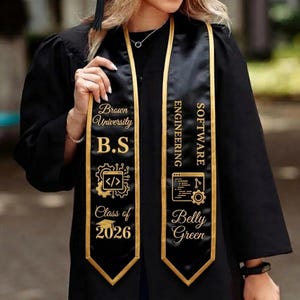 May include: Black graduation sash with gold trim and lettering. The sash reads "Brown University B.S" and "Class of 2026" on one side, and "Software Engineering Belly Green" on the other. The sash features computer-related graphics.