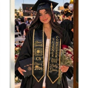May include: A graduate in a black cap and gown, holding a diploma and a bouquet of red roses. The sash reads "Computer Science" and "Brown University, CS Class of 2026, Belly Green."