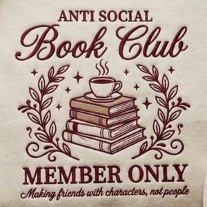 May include: Cream-coloured graphic with burgundy text reading "ANTI SOCIAL Book Club". A stack of books is topped with a coffee cup, surrounded by leaves and stars. The text "MEMBER ONLY" and "Making friends with characters, not people" are also included.