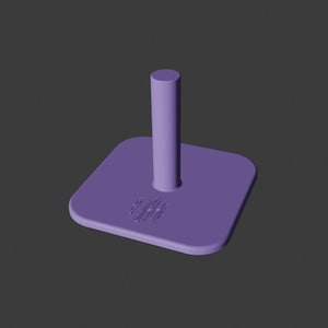 May include: A solid purple stand with a square base and a cylindrical post. The base has a small, stylized design etched into it. The stand is made of a smooth, matte material.