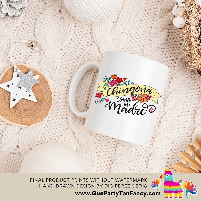 May include: White ceramic mug with a colorful floral design and the text "Chingona Como Mi Madre" in black lettering.