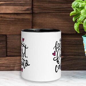 May include: White ceramic mug with a black rim. The mug has a pink heart and black text that reads "Best Friends, Cake & Coffee" on one side and "Best Friends, Cake & Coffee" on the other side.