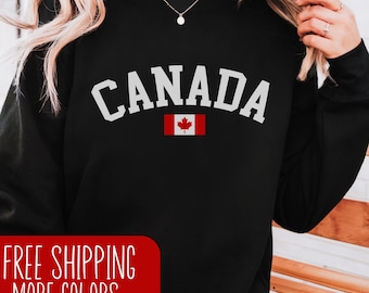 May include: Black sweatshirt with white text that reads "CANADA" and a small Canadian flag.