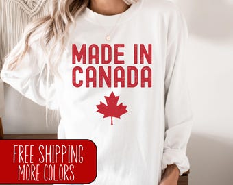 May include: White long-sleeve sweatshirt with red text that reads "Made in Canada" and a red maple leaf graphic.