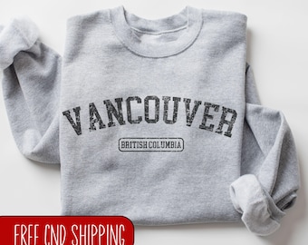 May include: Gray sweatshirt with the text "Vancouver, British Columbia" in a vintage-style font.