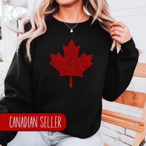 May include: Black sweatshirt featuring a red distressed maple leaf design. The text "CANADIAN SELLER" is visible at the bottom of the image.