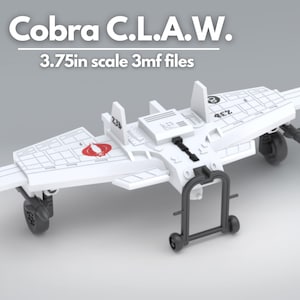 May include: White plastic model of a Cobra C.L.A.W. jet fighter with black landing gear and a Cobra logo on the top. The model is 3.75 inches in scale.