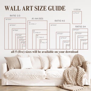 May include: Wall art size guide with dimensions in inches, including ratios 2:3, 4:5, and 3:4, plus A1-A4 (ISO) sizes. The text states that all five sizes are available for download. A white sofa with pillows and a blanket is in the foreground.