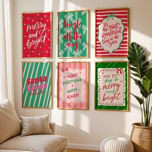 May include: A collection of six framed Christmas-themed art prints. The prints feature festive text like "Merry and Bright" and "Jingle All the Way" in various fonts and colors, set against backgrounds of red, green, and pink.