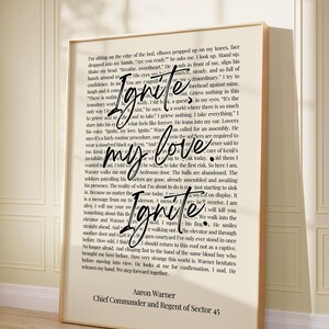 May include: A framed print with text from a novel, featuring the words "Ignite my love Ignite" in a stylized font. The text is set against a backdrop of printed pages, with a beige frame.