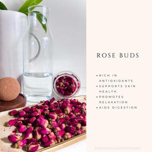 May include: Dried rose buds in a glass jar and on a gold tray. The text "ROSE BUDS" is written in black on a pink background. The text below reads: "RICH IN ANTIOXIDANTS, SUPPORTS SKIN HEALTH, PROMOTES RELAXATION, AIDS DIGESTION".