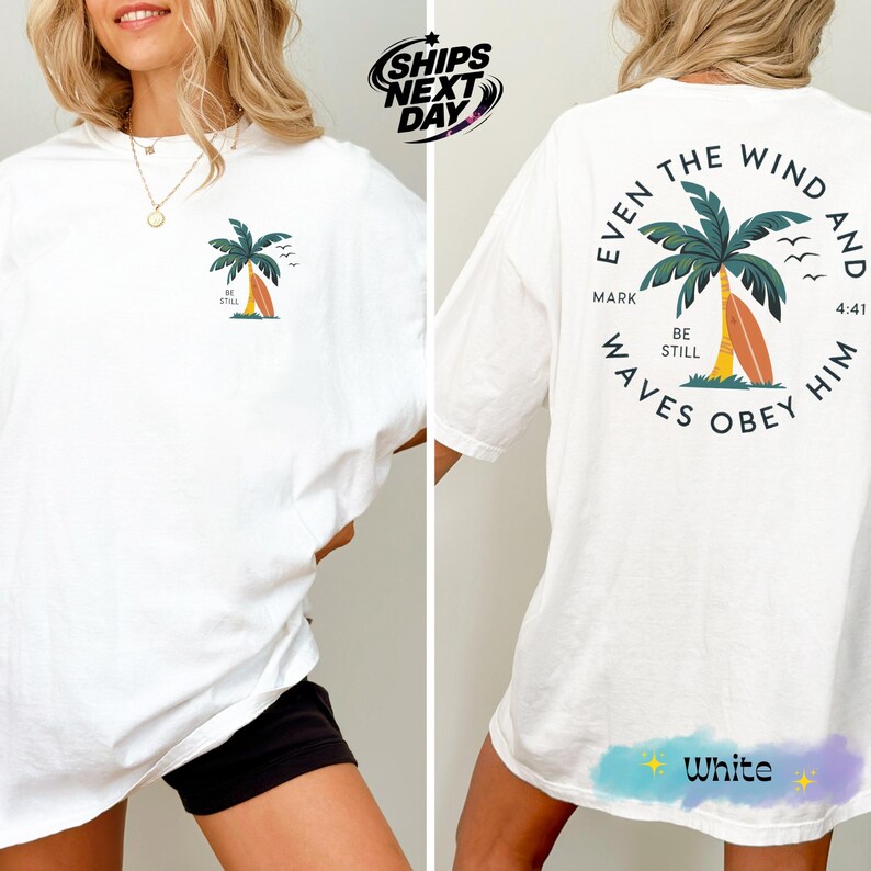 a woman wearing a white shirt with a palm tree on it