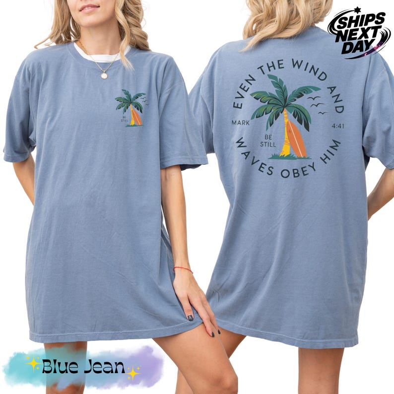 a woman wearing a blue shirt with a palm tree on it
