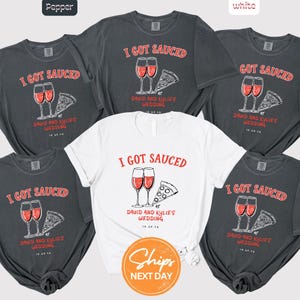May include: A collection of t-shirts in pepper and white, each featuring the text "I GOT SAUCED" above a graphic of two wine glasses and a pizza slice. The text "AT DAVID AND KYLIE'S WEDDING" is also included.