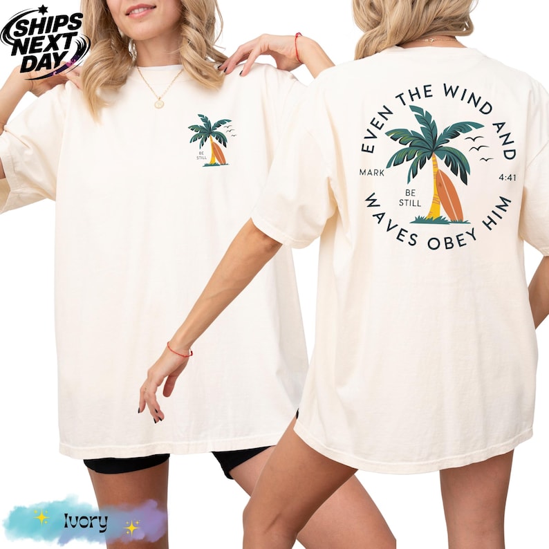 a woman wearing a white shirt with a palm tree on it