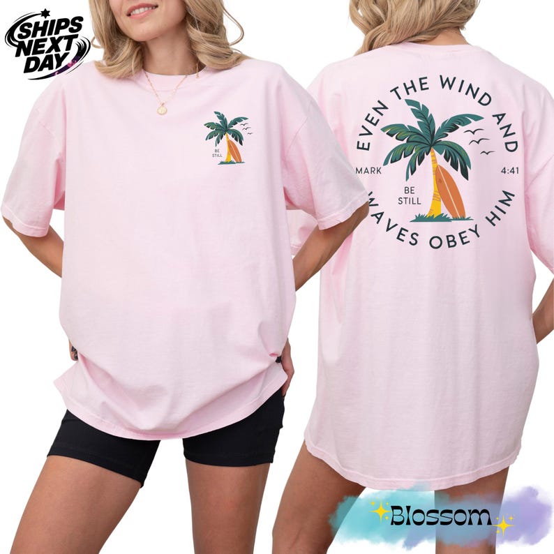 a woman wearing a pink shirt with a palm tree on it
